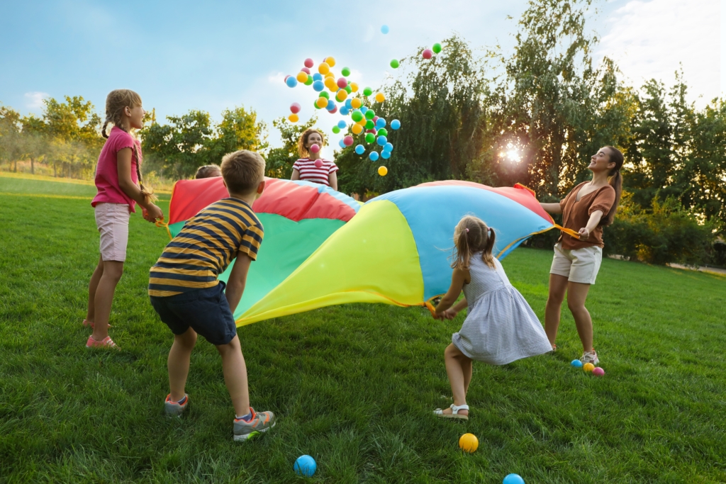 Young kids playing with parachute 